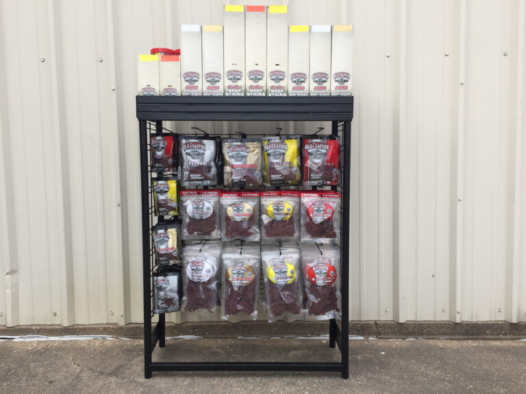 A variety of packaged snack foods arranged on a store shelf.